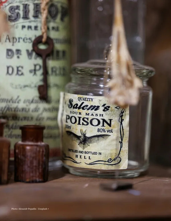 Page 4: a jar labeled Salem’s Poison with a bat on it, among old apothecary bottles and a key.